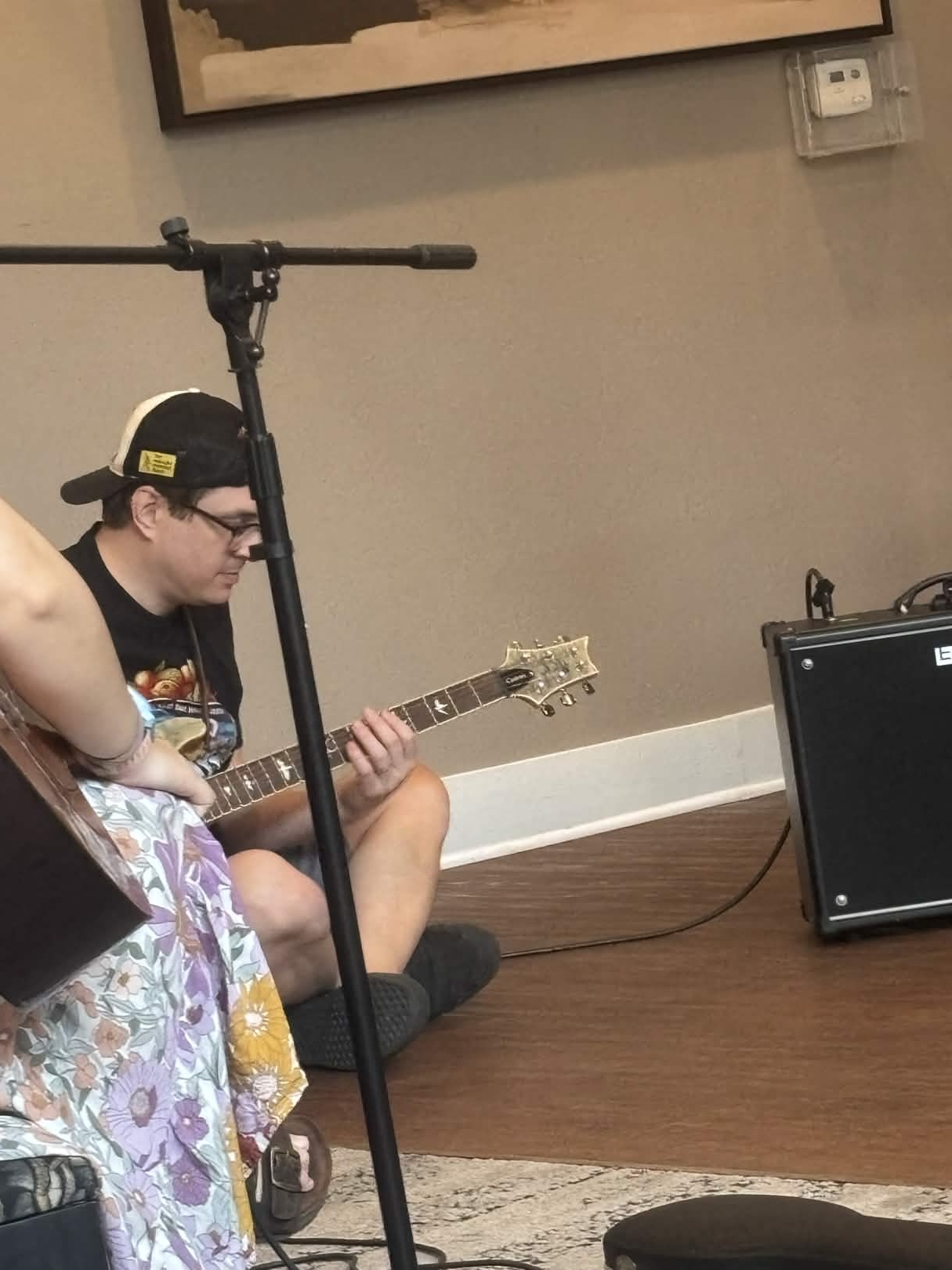 Van playing guitar on the floor